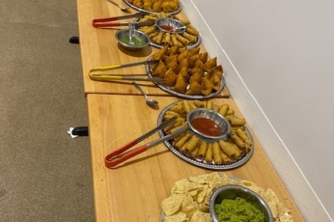 a wooden table topped with plates of food