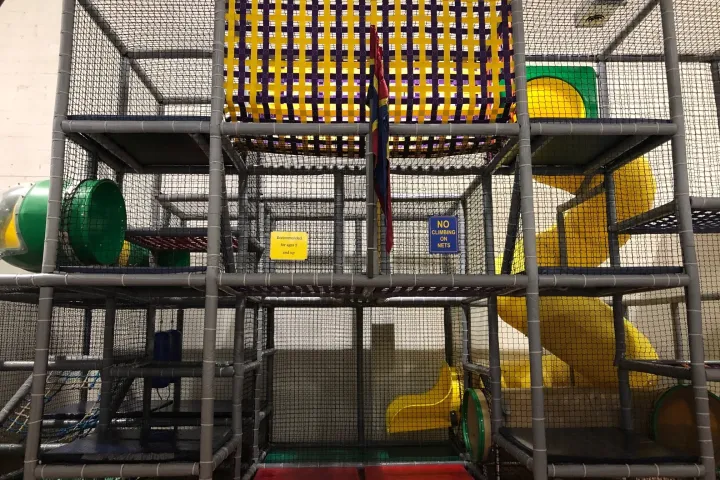 a store inside of a building with a metal fence