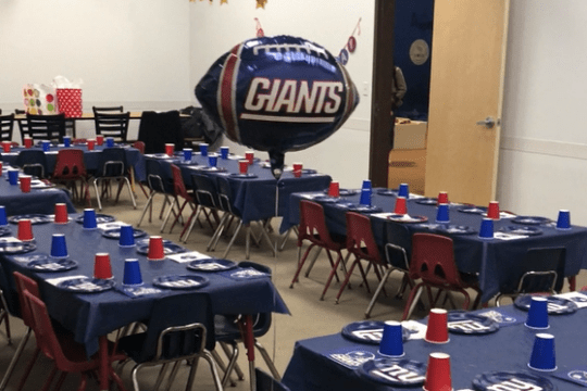 a group of people sitting at a desk in a room