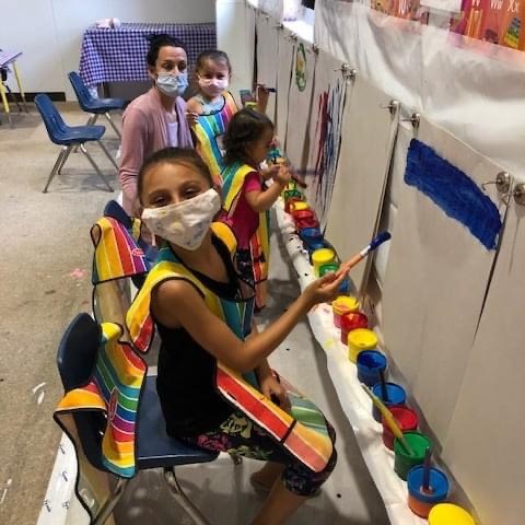 a little girl holding a toy