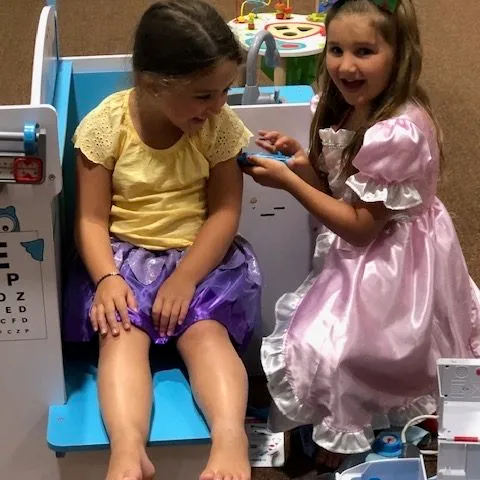 a little girl sitting on a table