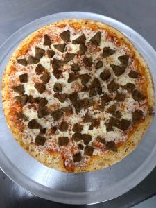 a pizza sitting on top of a metal pan