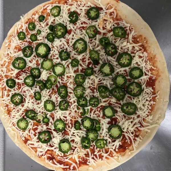 a pizza sitting on top of a pan on a table