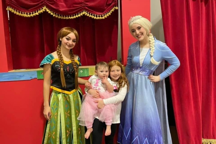 a man and a woman standing in front of a curtain