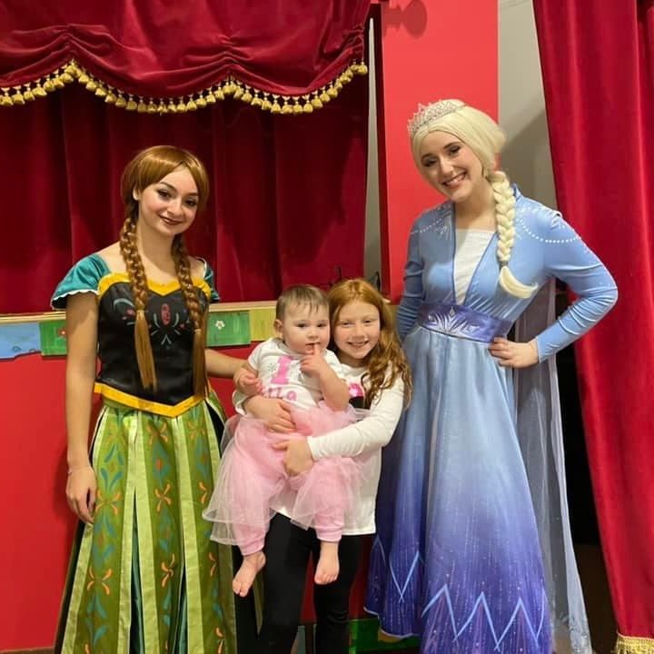 a man and a woman standing in front of a curtain