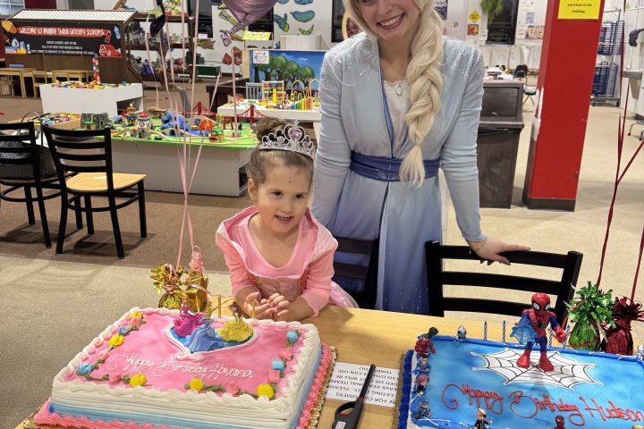 a person sitting on a bench in front of a birthday cake