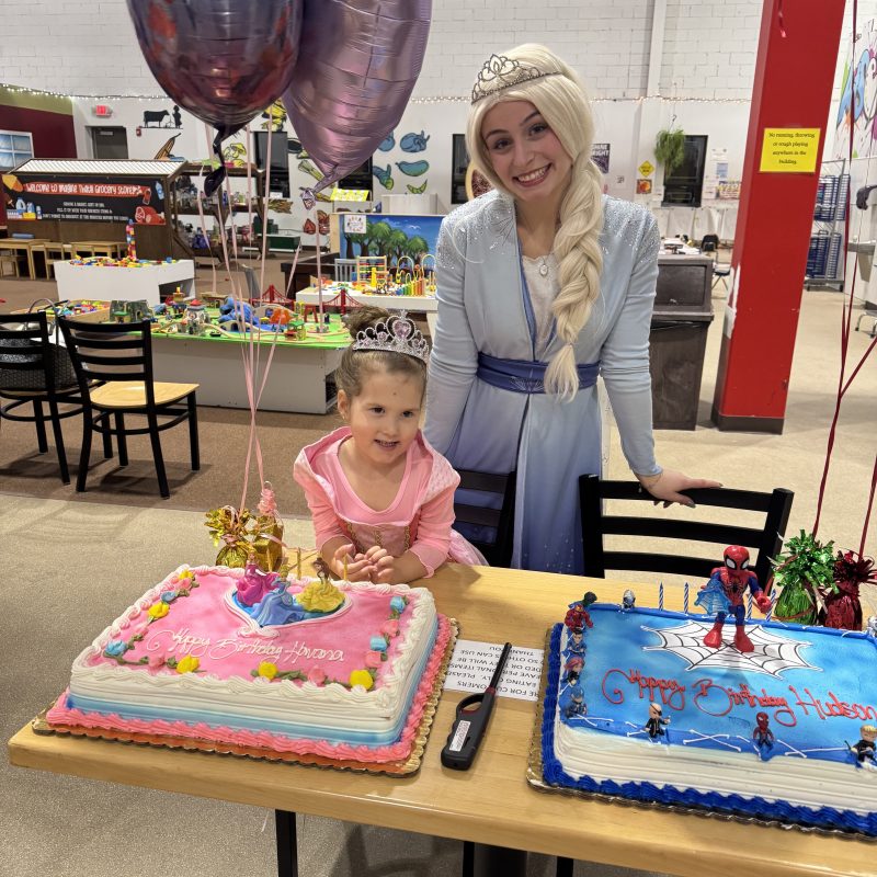 a person sitting on a bench in front of a birthday cake