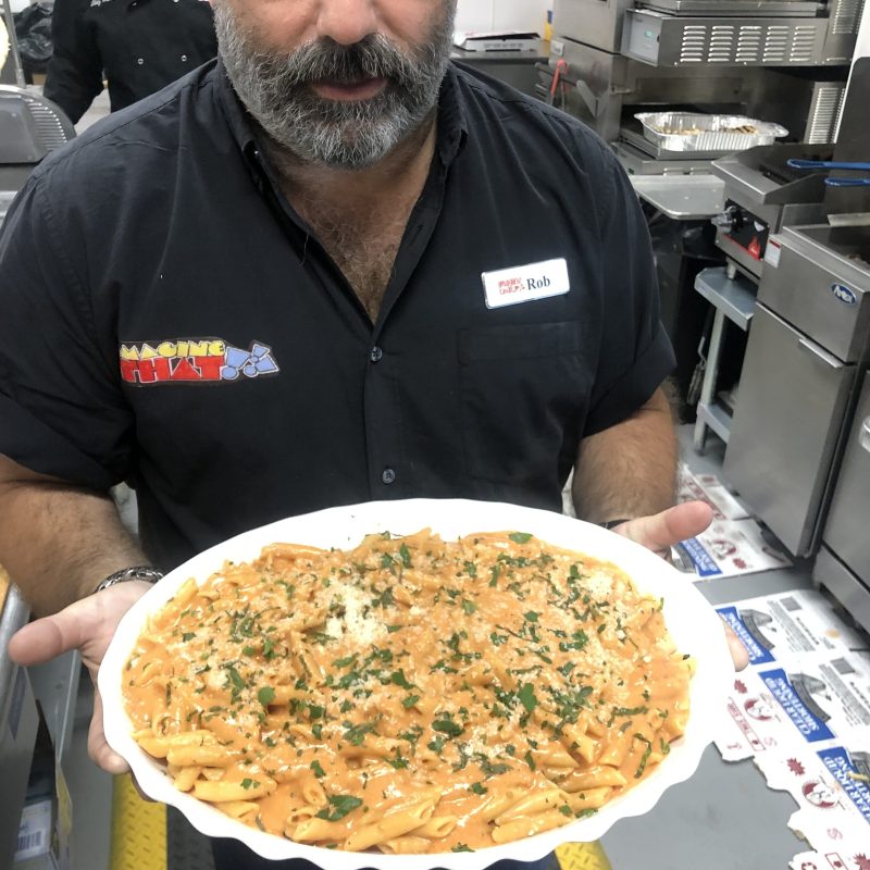 a man holding a pizza