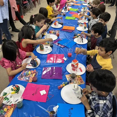 a group of people sitting at a table in front of a crowd